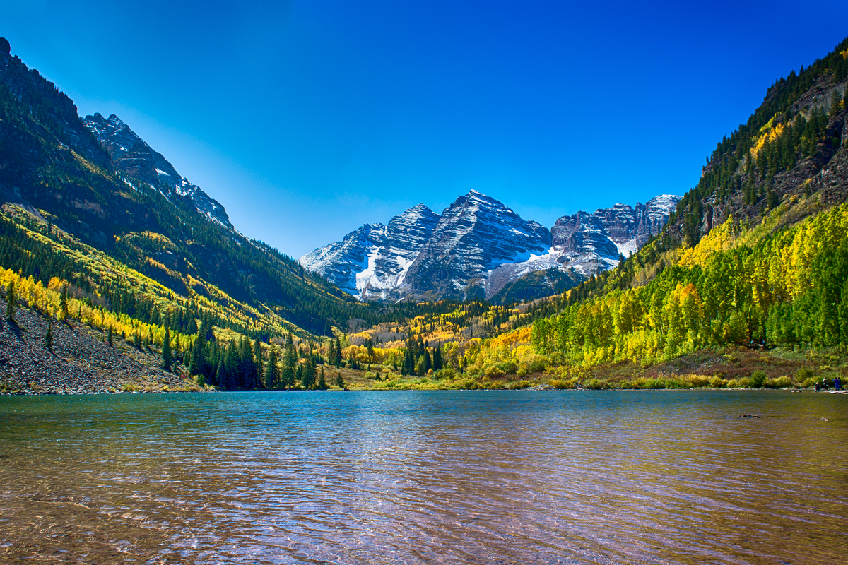 Maroon Bells peaks above a lake in autumn